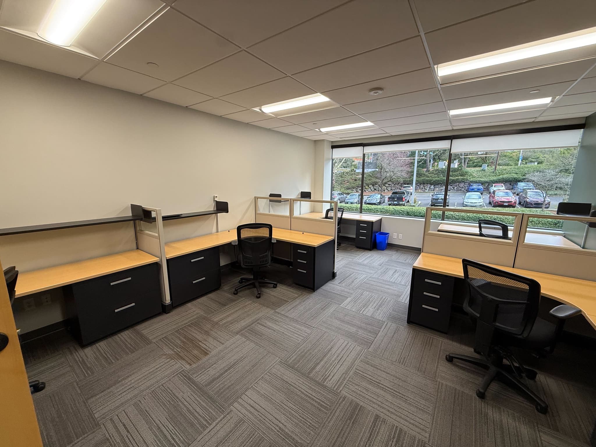 Team suite workspace with multiple workstations and natural lighting