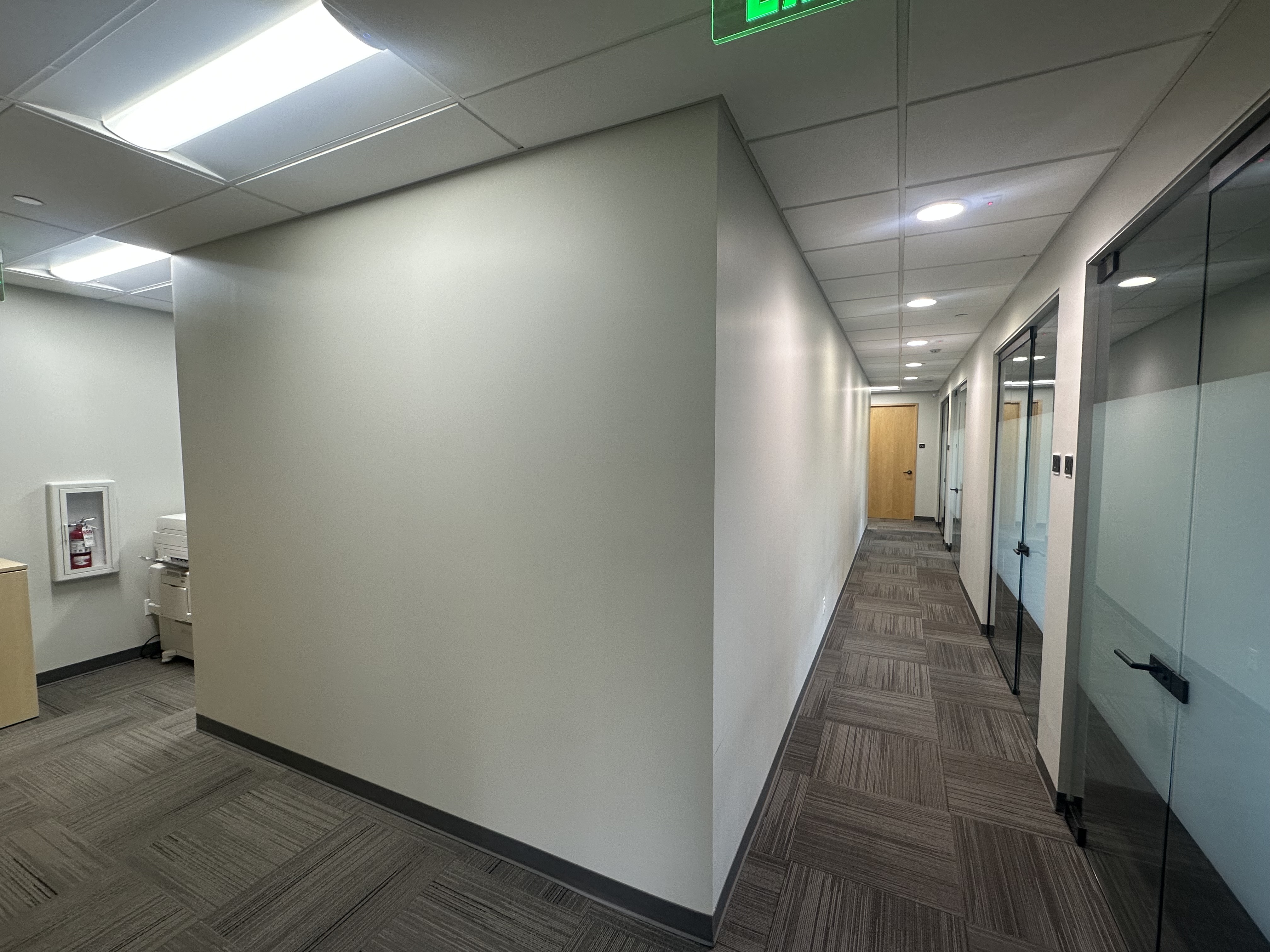 Professional office hallway with glass-walled offices